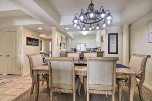 a dining room with a table and chairs at Barefoot Resort Condo with Balcony and Pool Views! in Myrtle Beach