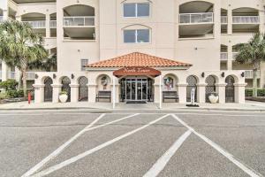 a hotel front with a parking lot in front of it at Barefoot Resort Condo with Balcony and Pool Views! in Myrtle Beach