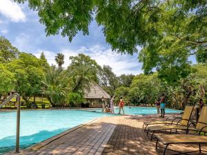 a pool at a resort with people playing in it at Leisure Time Rentals - Sanbonani Resort & Spa in Hazyview