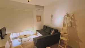 een woonkamer met een bank en een tafel bij STAY Vivid City Apartment in Limassol