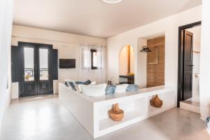 a living room with a couch and a tv at IfestAu.4 Suites in Fira +62 photos