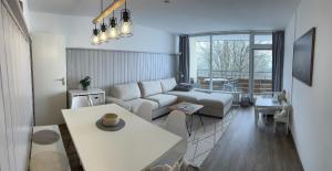 a living room with a couch and a table at Familienfreundliche Ferienwohnung Bayerischer Wald mit Pool in Freyung