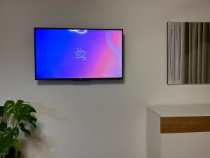 a flat screen tv hanging on a wall at E&E Home Sweet Home in Tirana