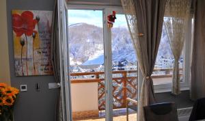 a room with a window with a view of a mountain at APARTMENTS FOKA&SPA - 600m from Gondola ski lift in Kopaonik