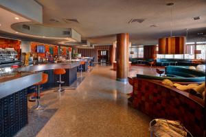 a restaurant with a bar with a pool table at Hotel Rey Sancho Ramírez in Barbastro