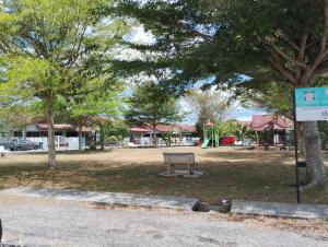 a park with a bench in the middle of a park at Ainul 74 Homestay in Pendang