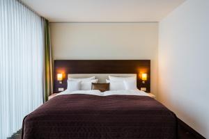 Postel nebo postele na pokoji v ubytování Hotel Esplanade Dortmund