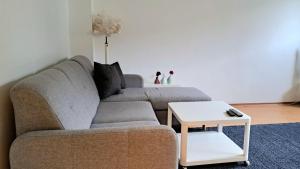 a living room with a couch and a table at Sea Side Apartment in Gdańsk