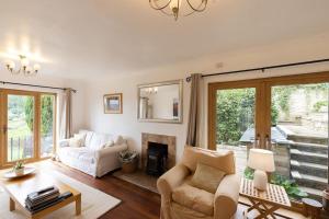 a living room with a couch and a fireplace at The Dormers - 5 BD Amazing Views of Stroud Valley 