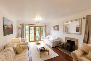 a living room with a couch and a fireplace at The Dormers - 5 BD Amazing Views of Stroud Valley 