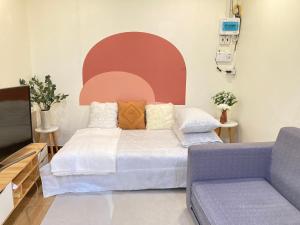 1 dormitorio con cama, sofá y TV en Tiny house at Santitham area near Nimman 4-6guests, en Chiang Mai
