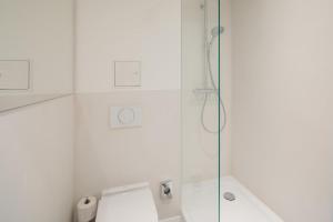 諾德奈的住宿－Nordstrandperle Ap O3，一间带卫生间和玻璃淋浴间的浴室