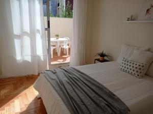 a bedroom with a bed and a table with a chair at Casa Lamela in Villasante +29 photos