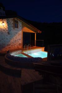 a swimming pool in front of a building at night at SOAP LADY Hotel and More in Mugla
