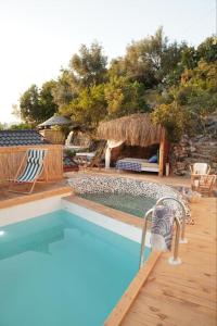 a swimming pool with chairs and a table and aiki at SOAP LADY Hotel and More in Mugla
