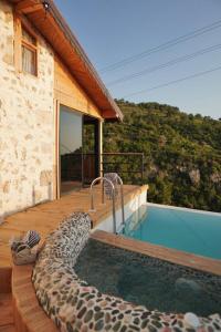 a large swimming pool next to a house at SOAP LADY Hotel and More in Mugla