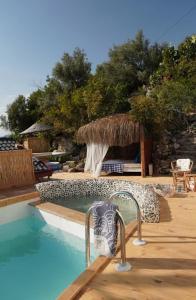 a swimming pool with a chair next to a house at SOAP LADY Hotel and More in Mugla