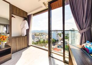 a hotel room with a view of the city at Ivy Hotel Nha Trang in Nha Trang