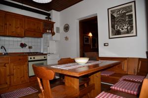 a kitchen with a wooden table with a bowl on it at via SOIA 1 in Canale dʼAgordo