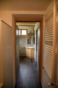 a hallway leading to a kitchen with a sink at via SOIA 1 in Canale dʼAgordo