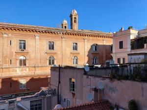 a large brick building with a clock tower on top at Piazza di Spagna - Suite Donata, strollingrome in Rome