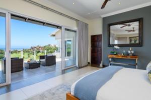 a bedroom with a bed and a view of the ocean at 11 on Fairway Beach Villa in Southbroom