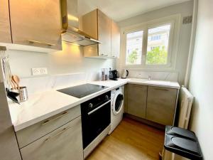 a small kitchen with a sink and a dishwasher at Pluton - SILS in Caen