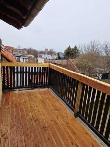 a wooden deck with a view of a city at Helle 3 Zimmerwohnung im Harz. in Halberstadt