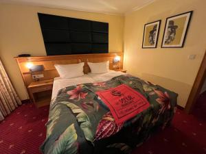 a hotel room with a bed with a sign on it at Das Seela Braunschweig in Braunschweig