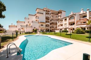 a building with a swimming pool in front of a building at Calahonda apartments - Los Jarales in Mijas Costa