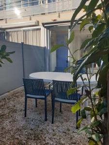 a table and two chairs and a table and chairs at Studio 4 personnes avec jardinet à 2 pas des plages "Chez Manon" in Carro