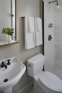 a bathroom with a toilet and a sink and a shower at Hotel G San Francisco in San Francisco