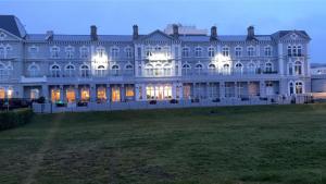 a large white building with its lights on at Royal Grosvenor Hotel in Weston-super-Mare