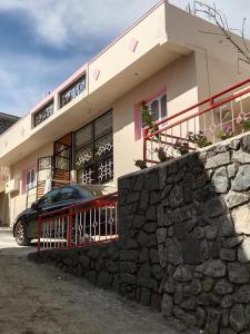 a house with a car parked in front of it at Olive Residency 4BHK Villa with a Parking, Wifi, Campfire, Homemade Food in Kodaikānāl