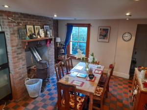 a dining room with a table and a fireplace at Annesley Park-Homestay AP in Dublin