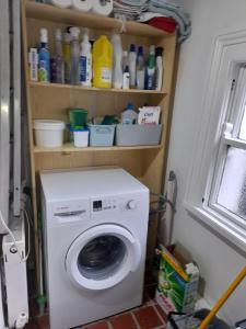 a washing machine in a room with a window at Annesley Park-Homestay AP in Dublin