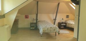 a bedroom with two beds in a attic at Maison Normande avec patio in Le Havre