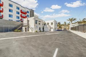 an empty parking lot in front of a building at Single Bedroom - Queen Size. Heart of Downtown Vista in Vista