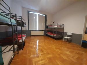 a room with bunk beds and a wooden floor at B3 Hostel Budapest in Budapest