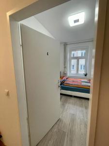 a room with a bed and a door with a window at Deluxe Studio 3P TH in Vienna