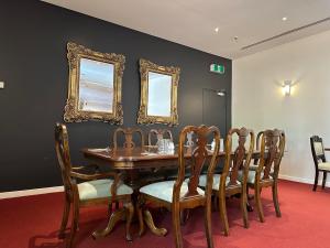 a dining room with a table and chairs and mirrors at The Grand Oaks Resort in Beechworth