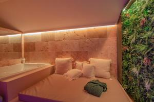 キュエールにあるLES BAINS D’EROSのバスタブの隣にソファがある小さな部屋