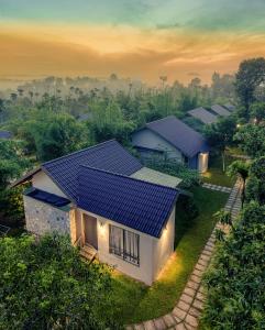a house with solar panels on top of it at Coffee Greens Resort in Wayanad