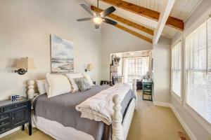 a bedroom with a bed and a ceiling fan at Lake Access and On-Site Creek Lake Toxaway Home! in Lake Toxaway +35 photos