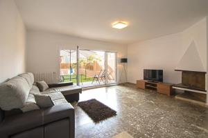 a living room with a couch and a television at Holiday home Splendid Park Güell in Barcelona