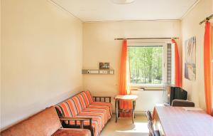 a living room with a couch and a window at Holiday home Klåvbensvägen Backaryd III in Backaryd