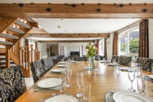 a dining room with a long table and chairs at Somersal Cottages in Ashbourne