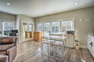 a kitchen and living room with a table and chairs at Pleasant Hill Studio with Pool and Hot Tub Access in Pleasant Hill