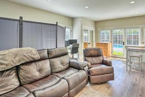 a living room with a couch and a chair at Pleasant Hill Studio with Pool and Hot Tub Access in Pleasant Hill
