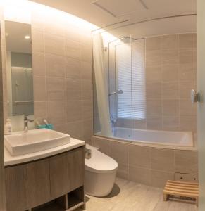 a bathroom with a sink and a toilet and a tub at 水晶- Suishou in Niseko